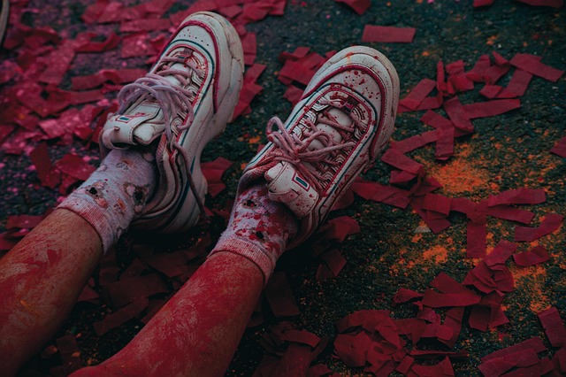 A close-up of vibrant, custom-painted sneakers, showcasing a unique aspect of personal style.