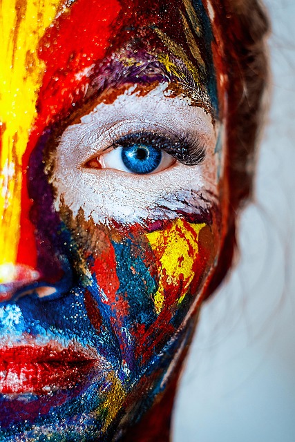 Close-up of a person with expressive, colorful makeup, embodying authenticity and vibrant self-expression.